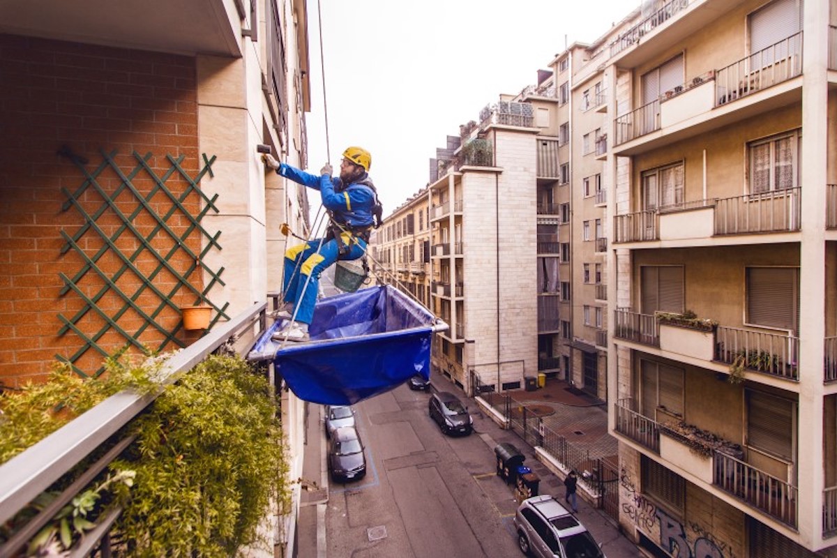 Operaio Acrobatica durante un'operazione di Rifacimento Cornicione condominiale
